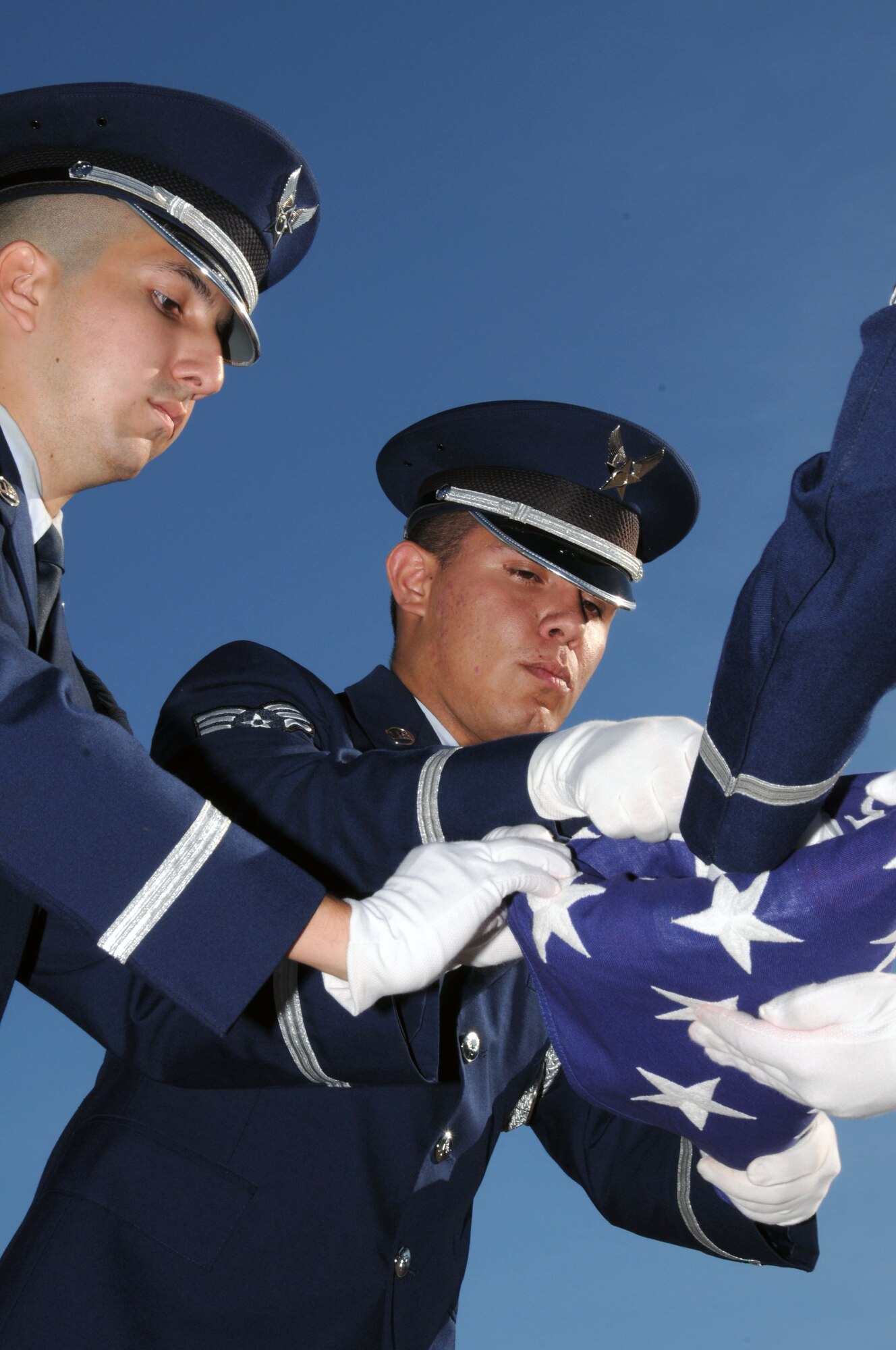 Members of the 103rd Base Honor Guard, 103rd Airlift Wing, finish folding the American Flag during a Sept. 11, 2010 flag-folding ceremony at the Bradley Air Park, Bradley Air National Guard Base, East Granby, Conn. (U.S. Air Force photo by Tech. Sgt. Theodore Andrews)