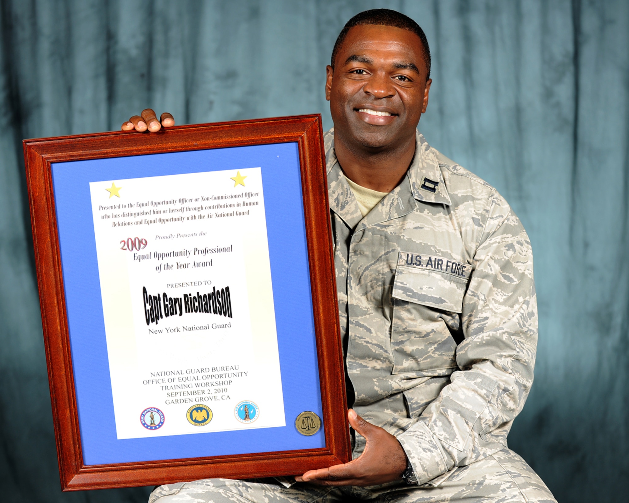 174th Fighter Wing Social Actions Officer, Captain Gary Richardson of the 174th Fighter Wing, Syracuse NY shows off the "Equal Opportunity Professional of the Year Award" he received at the September 2nd 2010 Annual National Guard EO conference held in Garden Grove, CA. (Us Air Force Photo by: Staff Sgt. James N. Faso II/Released)