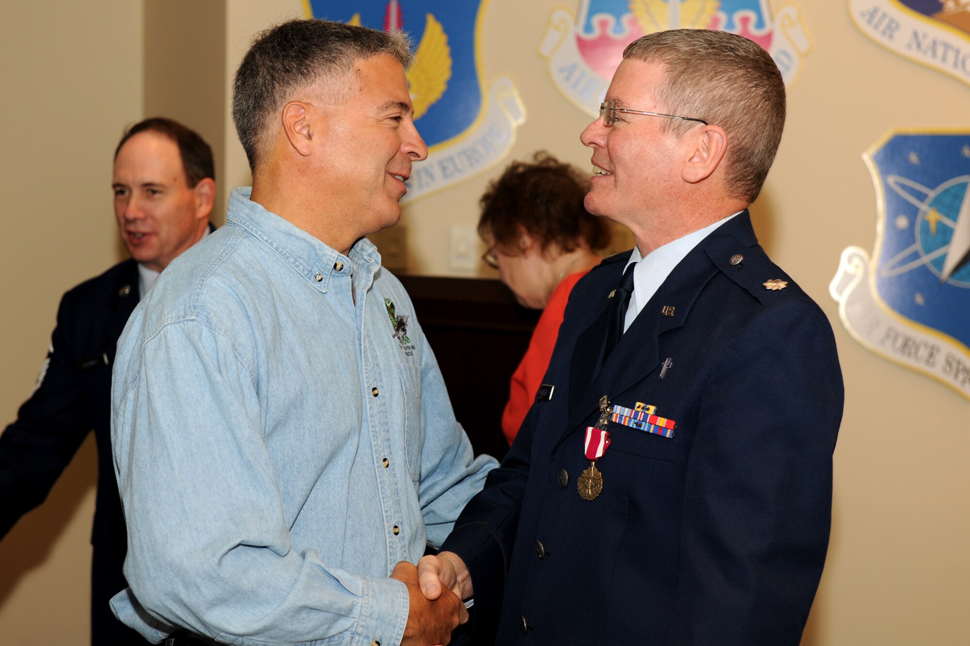 Col. (Ret.) Tony Basile, former Commander of the 174th Fighter Wing, congratulates Lt. Col. Decker on his retirement from the Air National Guard during his retirement on the 1st of October 2010. Lt. Col. Decker served more than 24 years in the Air Force and Air National Guard and had been assigned as the 174th FW Chaplain for the past 10 years. (US Air Force Photo by: SSgt James N. Faso II/Released)