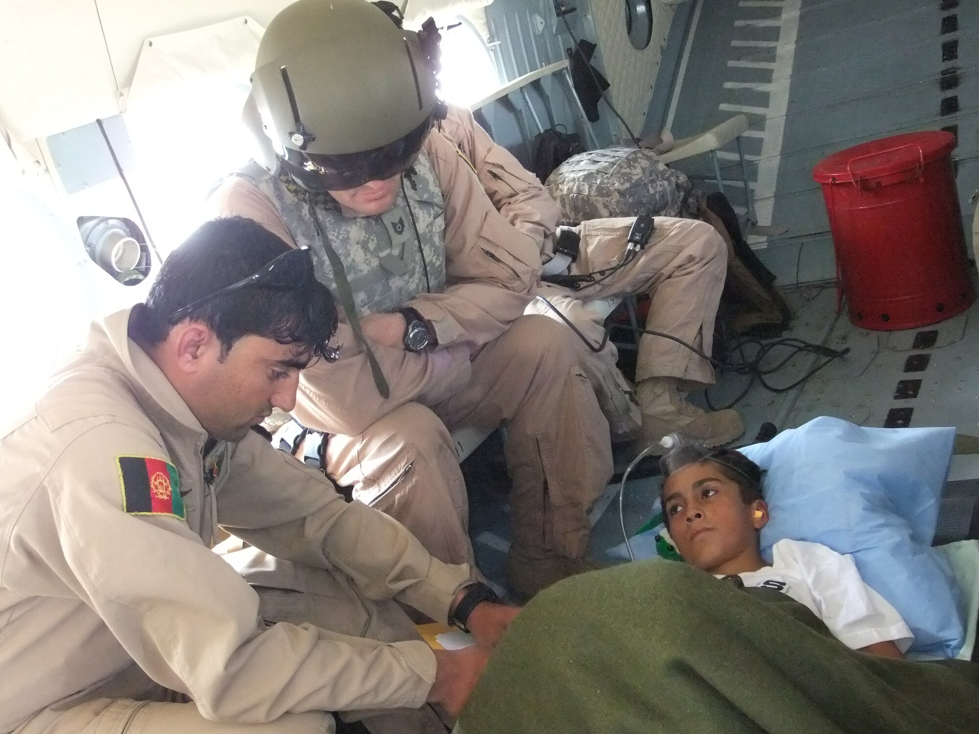 Afghan Airmen and NATO Air Training Command - Afghanistan advisors worked as one to transfer a patient from Bagram Airfield during a reverse aeromedical evacuation mission to Forward Operating Base Bostic in Konar Province, Afghanistan on Sept 27, 2010.