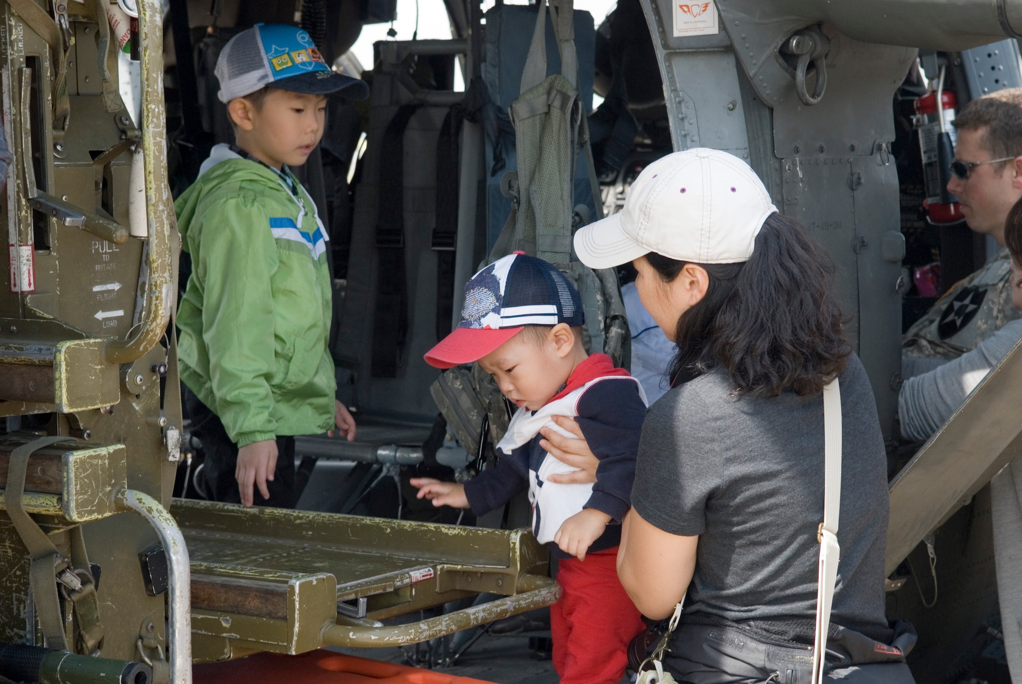 KUNSAN AIR BASE, Republic of Korea -- Gunsan City citizens check out a U.S. Army UH-60 Blackhawk during the Kunsan Air Base Open House and Gunsan Appreciation Day here Oct. 1, 2010. The base opened its doors to the local community and held events including an F-16 fly-by, Korean dance performances, static displays, organizational booths, military working dog demonstrations, aircraft munitions-loading competitions, music and more. (U.S. Air Force photo/Senior Airman Ciara Wymbs)