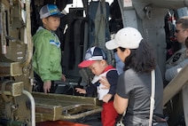 KUNSAN AIR BASE, Republic of Korea -- Gunsan City citizens check out a U.S. Army UH-60 Blackhawk during the Kunsan Air Base Open House and Gunsan Appreciation Day here Oct. 1, 2010. The base opened its doors to the local community and held events including an F-16 fly-by, Korean dance performances, static displays, organizational booths, military working dog demonstrations, aircraft munitions-loading competitions, music and more. (U.S. Air Force photo/Senior Airman Ciara Wymbs)