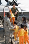 KUNSAN AIR BASE, Republic of Korea -- Airman First Class Nareef Ali, 8th Aircraft Maintenance Squadron, and Capt. Jondavid Hertzel, 80th Fighter Squadron, help Gunsan City school children look into an F-16 Fighting Falcon cockpit during the Kunsan Air Base Open House and Gunsan Appreciation Day here Oct. 1, 2010. The base opened its doors to the local community and held events including an F-16 fly-by, Korean dance performances, static displays, organizational booths, military working dog demonstrations, aircraft munitions-loading competitions, music and more. (U.S. Air Force photo/Senior Airman Ciara Wymbs)