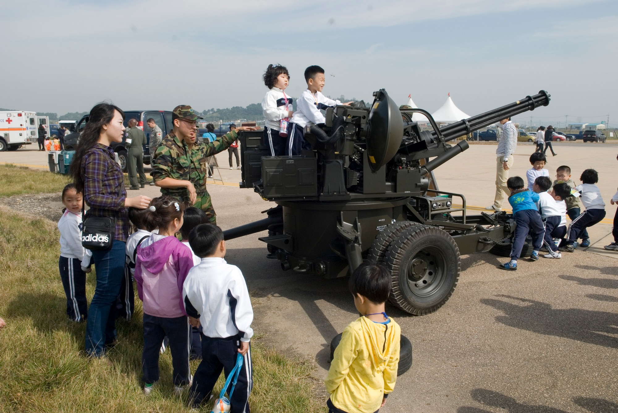 KUNSAN AIR BASE, Republic of Korea -- Republic of Korea Air Force Airmen talk to Gunsan City school children during the Kunsan Air Base Open House and Gunsan Appreciation Day here Oct. 1, 2010. The base opened its doors to the local community and held events including an F-16 Fighting Falcon fly-by, Korean dance performances, static displays, organizational booths, military working dog demonstrations, aircraft munitions-loading competitions, music and more. (U.S. Air Force photo/Senior Airman Ciara Wymbs)