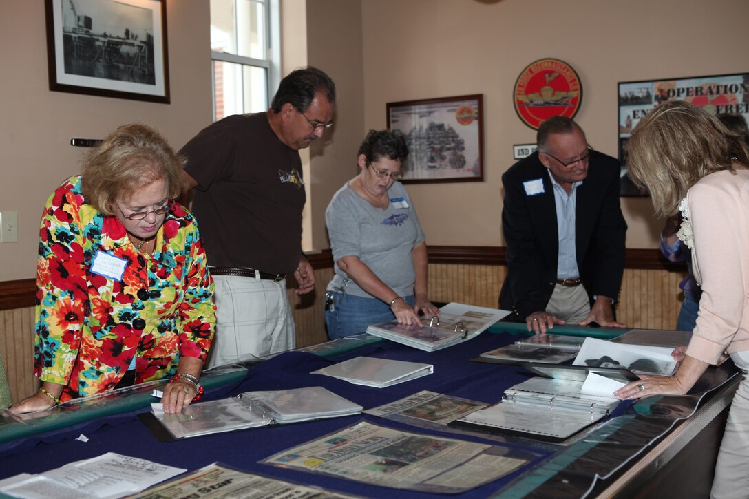 Descendants of former landowners of Marine Corps Base Camp Lejeune look at scrapbook pages during the landowners annual reunion at Courthouse Bay aboard the base, Oct. 3.  Original landowners and family members – some who spanned more than five generations – traveled from across the nation to attend the event.