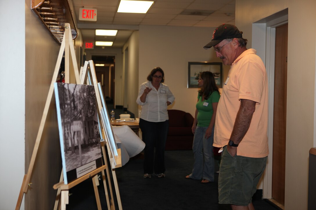 Descendants of former landowners of Marine Corps Base Camp Lejeune look at old photographs during the landowners annual reunion at Courthouse Bay aboard the base, Oct. 3.  Original landowners and family members looked at old photographs, scrapbooks and newspaper clippings, some of which dated back to the early 1900s.