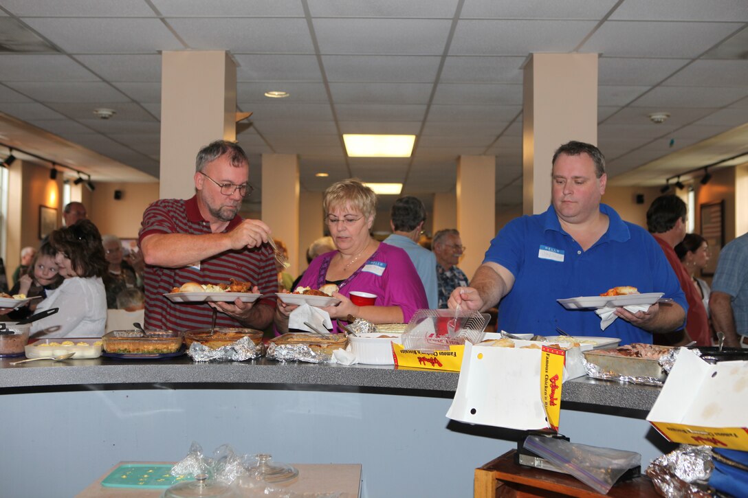 Descendants of former landowners of Marine Corps Base Camp Lejeune go through the serving line of the potluck luncheon during the landowners annual reunion at Courthouse Bay aboard the base, Oct. 3.  Original landowners and family members looked at old photographs, scrapbooks and newspaper clippings, some of which dated back to the early 1900s.