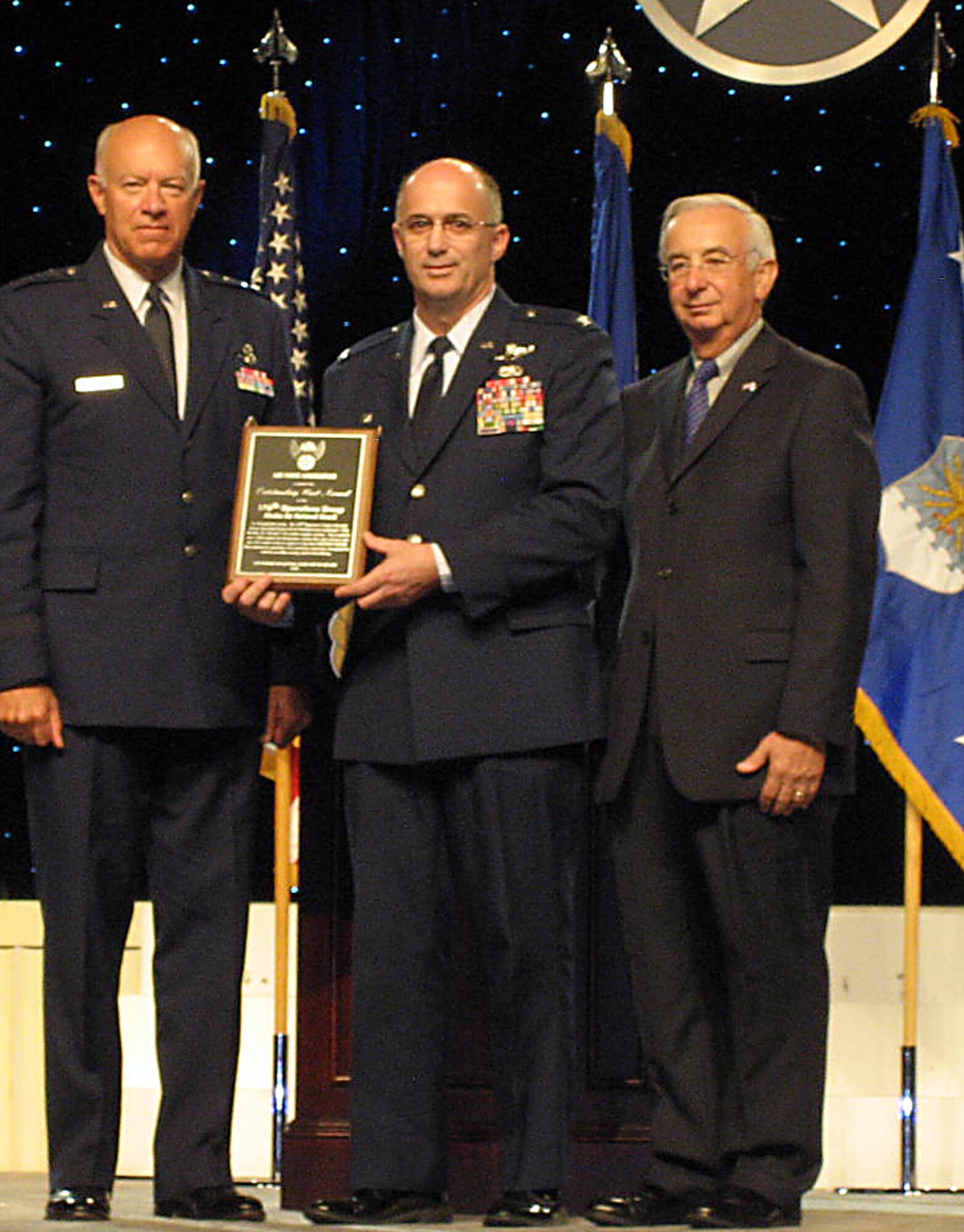 Col. Carlisle A. Lincoln,  commander of the Alaska Air National Guard's 176th Operations Group, accepts the Air Force Association's 2010 Outstanding Air National Guard Unit of the Year award Sept. 13, 2010 in Washington D.C. Michael M. Dunn (right), the Air Force Association president, and Lt. Gen. Harry M. Wyatt III, the Air National Guard director, present the award.