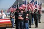 The family of Chief Warrant Officer 3 Matthew G. Wagstaff hugs near his casket shortly after his remains arrived at the Utah Air National Guard base in Salt Lake City, Utah, on October 3, 2010. CW3 Wagstaff was a UH-60 Blackhawk pilot who died in Afghanistan September 21. He was serving on his third deployment at the time. (U.S. Air Force photo by Master Sergeant Gary J. Rihn)(RELEASED)
