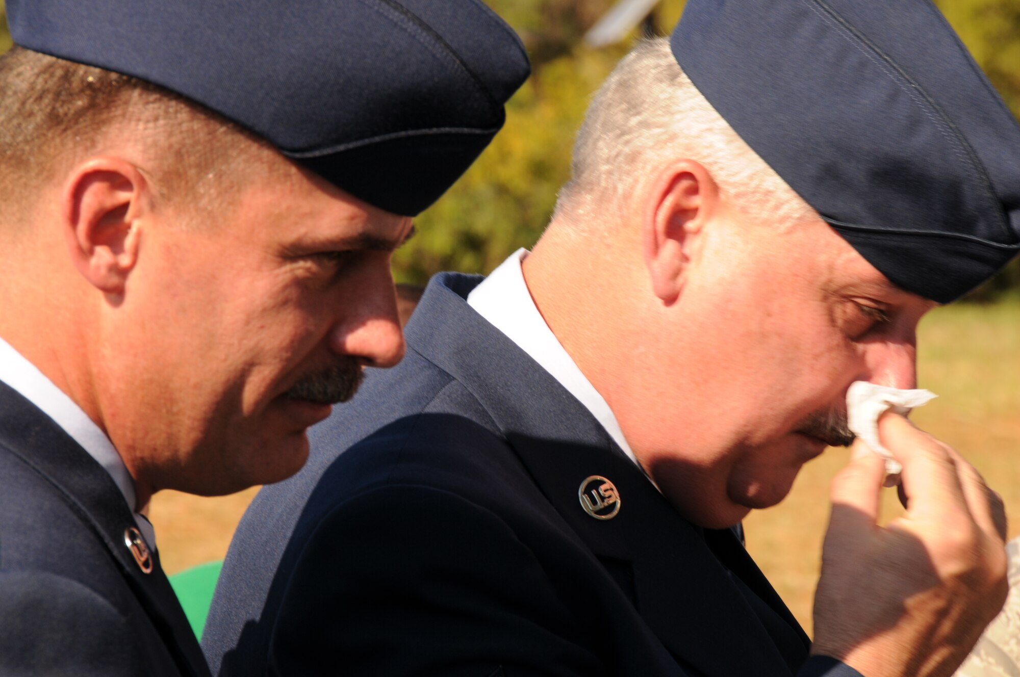 Charlotte, N.C. -- Chief Master Sgt. Douglas Rook shares a somber moment with Tech. Sgt. Edward Dennis as Dennis’s father is paid tribute at a memorial service honoring North Carolina Air National Guardsmen deceased in the last year. (NCANG photo by Tech. Sgt. Rich Kerner)
