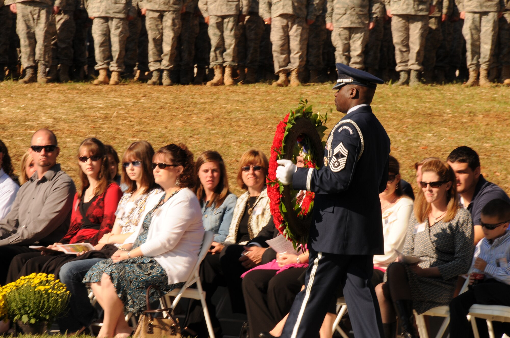 Chief Master Sgt. Maurice Williams marches by surviving family members with a memorial wreath for the memorial service honoring North Carolina Air National Guardsmen deceased in the last year. (NCANG photo by Tech. Sgt. Rich Kerner)
