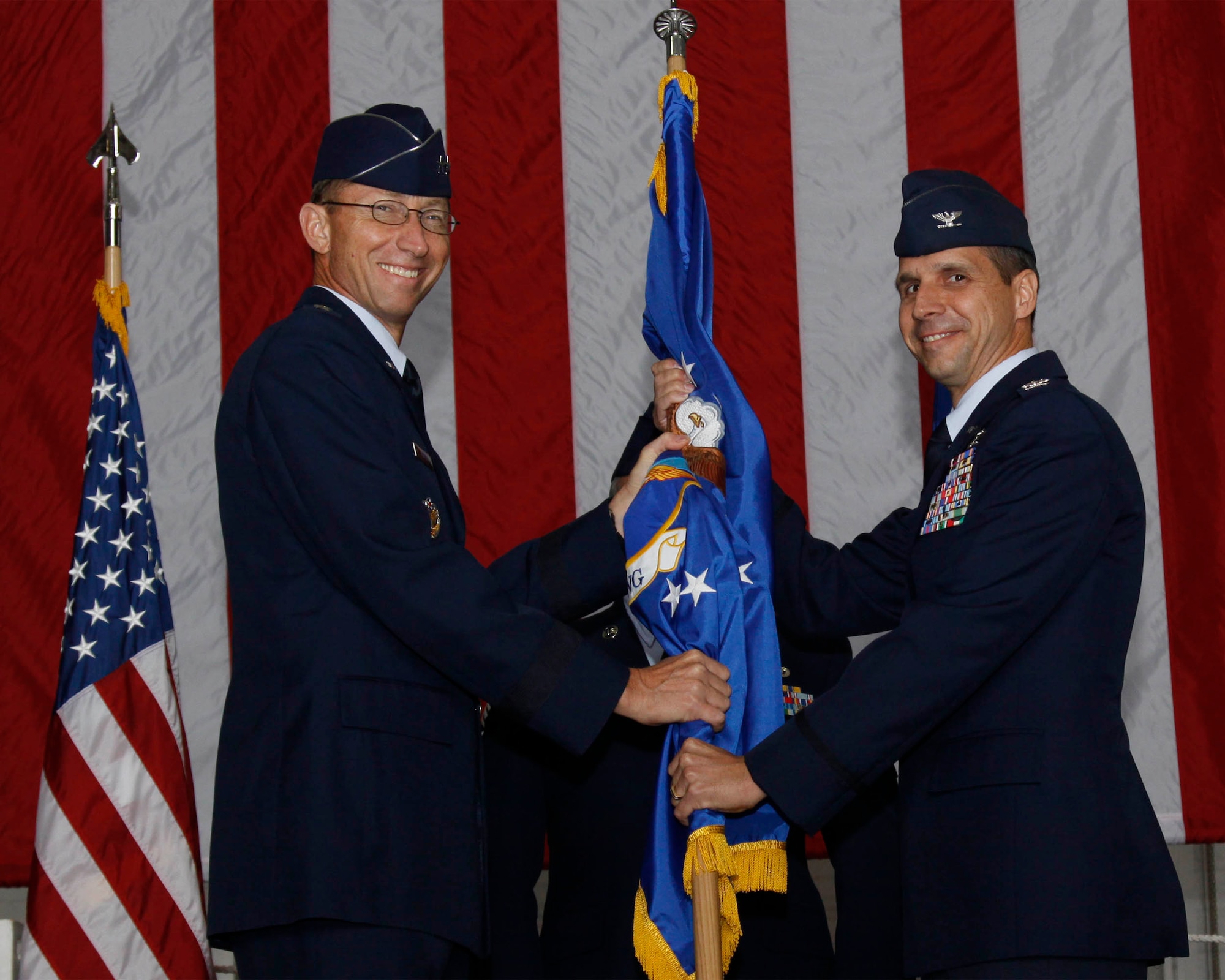 Pittsburgh IAP Air Reserve Station, Pa. - - Maj. Gen. James T. Rubeor, 22nd Air Force commander, hands the guidon to Col. Jeffrey T. Pennington during a change of command ceremony here Oct. 3. Colonel Pennington assumed command of the 911th Airlift Wing. As installation commander, he is the senior officer responsible for the wing organization, which includes authorized manning of 1,263 Air Force Reserve members and approximately 320 civilian employees, including more than 184 dual-status air reserve technicians. (Photo Illustration by Airman First Class Melissa Knox)