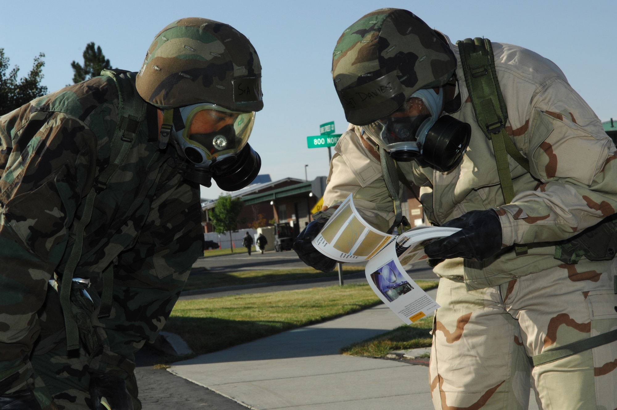 Senior Airman Adrian Hamilton, 151st Logistics Readiness Squadron, watches and listens closely as Staff Sergeant Shawn Davies, 151st LRS, shows him the proper way to conduct a Post Attack Reconnaissance using M9 Chemical Agent Detection Paper during an Ability to Survive and Operate (ATSO) exercise conducted October 2, 2010. (U.S. Air Force photo by Tech. Sgt. Kelly K. Collett)(RELEASED)