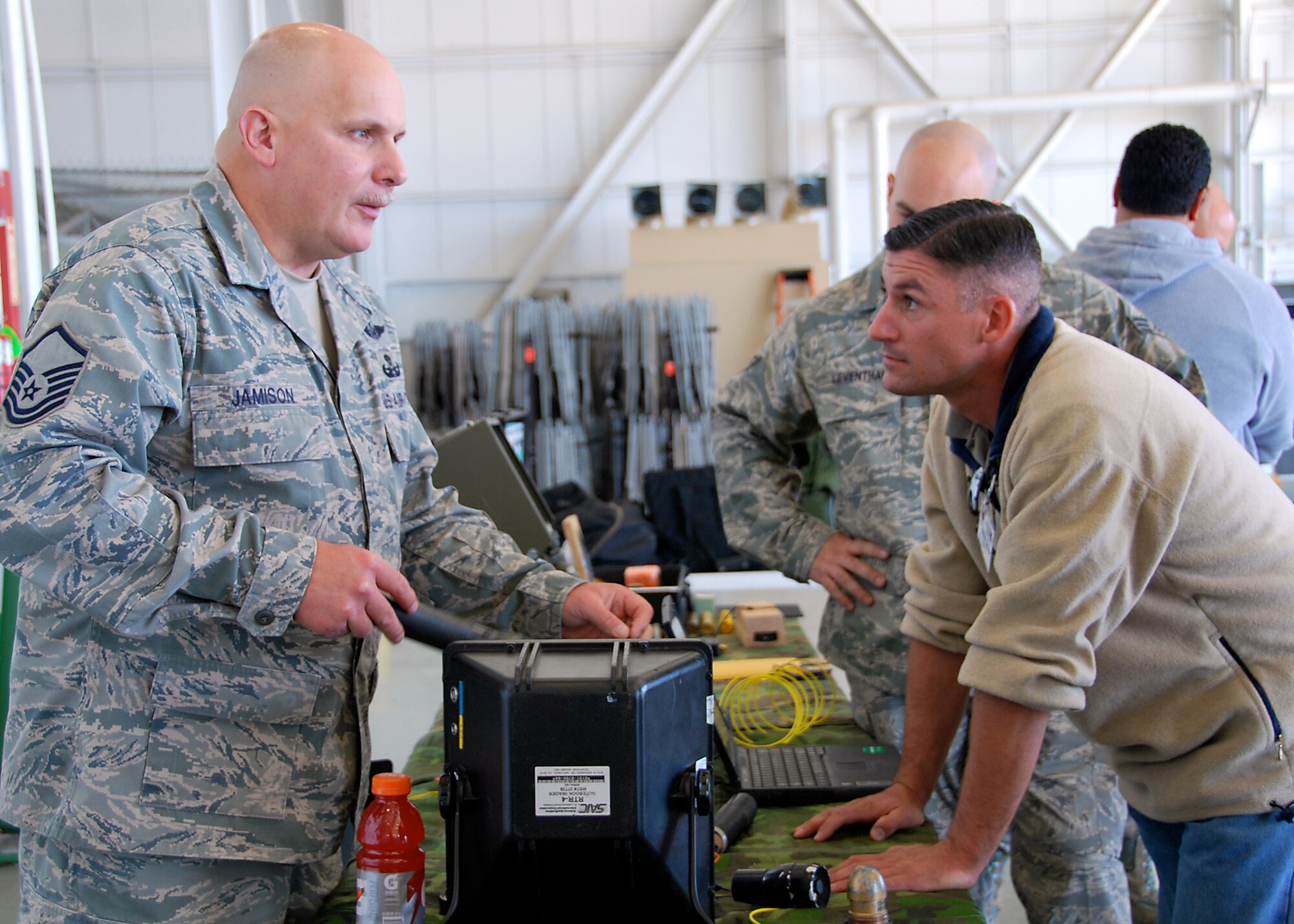 JOINT BASE MCGUIRE-DIX-LAKEHURST, N.J. ? Master Sgt. Richard Jamison, 514th Civil Engineer Squadron, discusses the functions of a variety of explosive ordnance disposal equipment with the civilian employer of an Air Force reservist during Employee Appreciation Day here Oct. 2. (U.S. Air Force photo/Staff Sgt. Monica Dalberg)