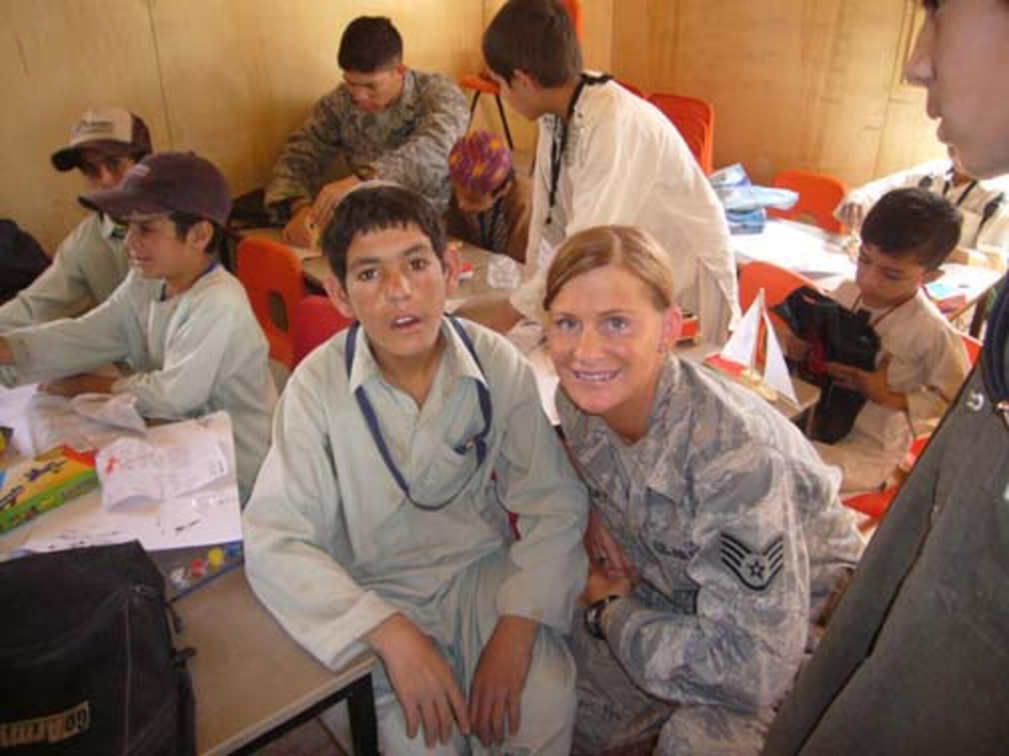 SSgt Aimi  Mlekoday from the 507th Civil Engineer Squadron is shown assisting a Afghanistani student at the Commander Kandahar Air Field-sponsored Bazaar School.   Mlekoday, from Norman, Oklahoma,  is an Air Force Reserve Operations Management Helper currently deployed supporting military operations in the region while assigned to the 777th Expeditionary Prime Beef Squadron. 
