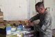 Staff Sergeant Christopher Guild inspects a product shipment at al Udeid Air Base in Soutwest Asia, where he is deployed as a food service technician. He is a member of the 184th Force Support Squadron.