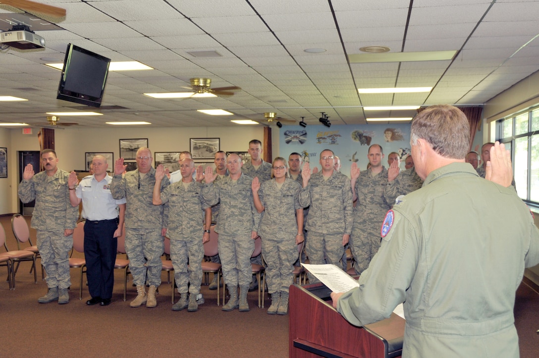 Col. Russ walz recites the oath of enlistment with a group of Airmen from the 114th Fighter wing at a reenlistment ceremony Sept. 12, 2010 (Air Force Photo by Master Sgt. Christopher Stewart, 114th Fighter Wing)
