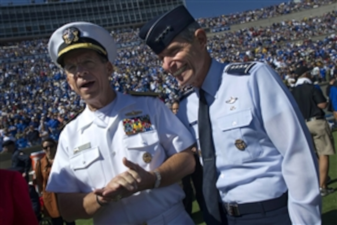 U.S. Navy Adm. Mike Mullen, chairman of the Joint Chiefs of Staff, left, and U.S. Air Force Chief of Staff Gen. Norton A. Schwartz, right, meet on the Falcon Stadium field prior to the kickoff of the U.S. Air Force Academy Falcons vs.  the U.S. Naval Academy Midshipmen football game in Colorado Springs, Colo., Oct. 2, 2010. The Falcons ended a seven-year drought defeating the Midshipmen 14-6. 