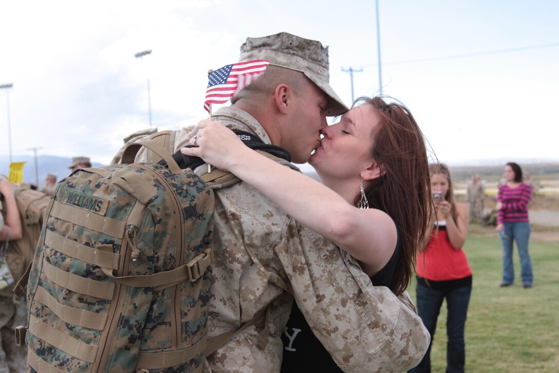 Corporal Joshua Williams, a radio operator for Regimental Combat Team 7, kisses his wife, Cheyenne, during the homecoming of RCT-7’s main body Oct. 4, 2010, at Del Valle Field.