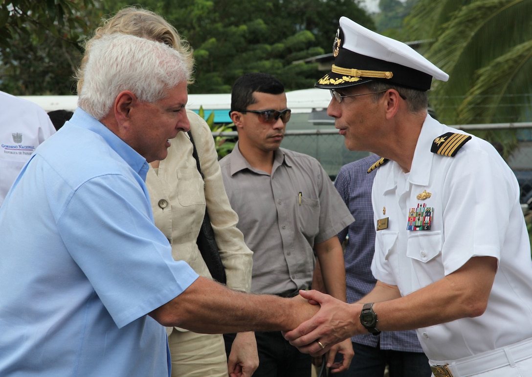 Panamanian President Ricardo Martinelli shakes hands with Navy Capt. Thomas M. Negus, commodore of Continuing Promise 2010, during the president's visit to a medical site in Punta Pena, Oct. 4. Marines, sailors, soldiers, airmen, civilians and Panamanian citizens attended a presidential visit along with Vice President Juan Carlos Varela; Phyllis M. Powers, U.S. ambassador to Panama; and Franklin Vergara, Panama’s minister of health. CP10 personnel are anchored off the coast of Chiriqui Grande, Panama, to conduct humanitarian operations to the Caribbean, Central and South America.