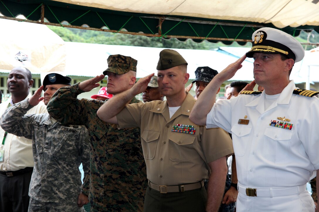(From right) Navy Capt. Thomas J. Chassee, commanding officer of USS Iwo Jima; Lt. Col. Chris S. Richie, commanding officer of Special-Purpose Marine Air-Ground Task Force Continuing Promise 2010; Sgt. Maj. Kevin J. Gilligan, sergeant major of Marine Medium Helicopter Squadron 774; and Army Col. Gregory Barrack, U.S. Senior Defense Official to the Republic of Panama, salute the national ensign during the playing of the U.S. national anthem at a presidential visit in Punta Pena, Oct. 4. Marines, sailors, soldiers, airmen, civilians and Panamanian citizens attended a visit by Panamanian President Ricardo Martinelli, Vice President Juan Carlos Varela; Phyllis M. Powers, U.S. ambassador to Panama; and Franklin Vergara, Panama’s minister of health. CP10 personnel are anchored off the coast of Chiriqui Grande, Panama, to conduct humanitarian operations to the Caribbean, Central and South America.