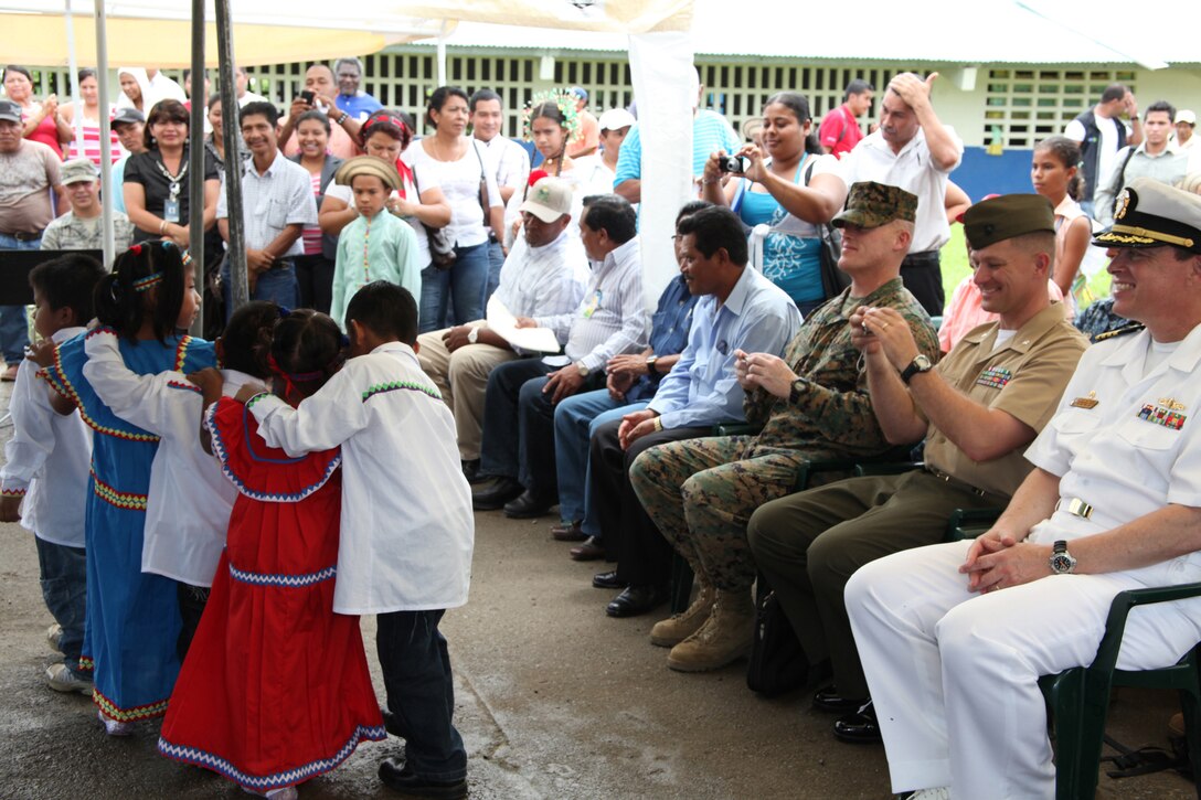 (From right) Navy Capt. Thomas J. Chassee, commanding officer of USS Iwo Jima; Lt. Col. Chris S. Richie, commanding officer of Special-Purpose Marine Air-Ground Task Force Continuing Promise 2010; Sgt. Maj. Kevin J. Gilligan, sergeant major of Marine Medium Helicopter Squadron 774, watch as Panamanian children perform a cultural dance during the presidential visit at a medical site in Punta Pena, Oct. 4. Marines, sailors, soldiers, airmen, civilians and Panamanian citizens attended a visit by Panamanian President Ricardo Martinelli, Vice President Juan Carlos Varela; Phyllis M. Powers, U.S. ambassador to Panama; and Franklin Vergara, Panama’s minister of health. CP10 personnel are anchored off the coast of Chiriqui Grande, Panama, to conduct humanitarian operations to the Caribbean, Central and South America.