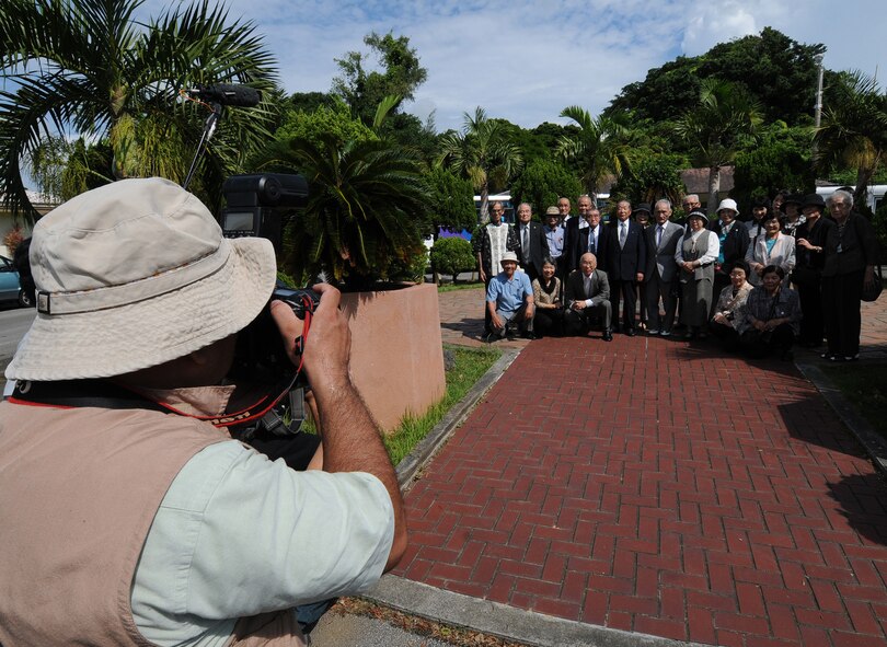 Japanese media take photos and video of 28 World War II veterans and their families posing in front of Kadena Air Base's Peace Garden Sept. 30. Members of the Japanese Disabled Veterans Association, many of which served in places like Burma, Africa and China, visited two of Kadena's historic war sites. The group represented a dwindling number of war veterans from the Tokyo area, Kyushyu and Okinawa. (Air Force/Tech. Sgt. Jason Lake)