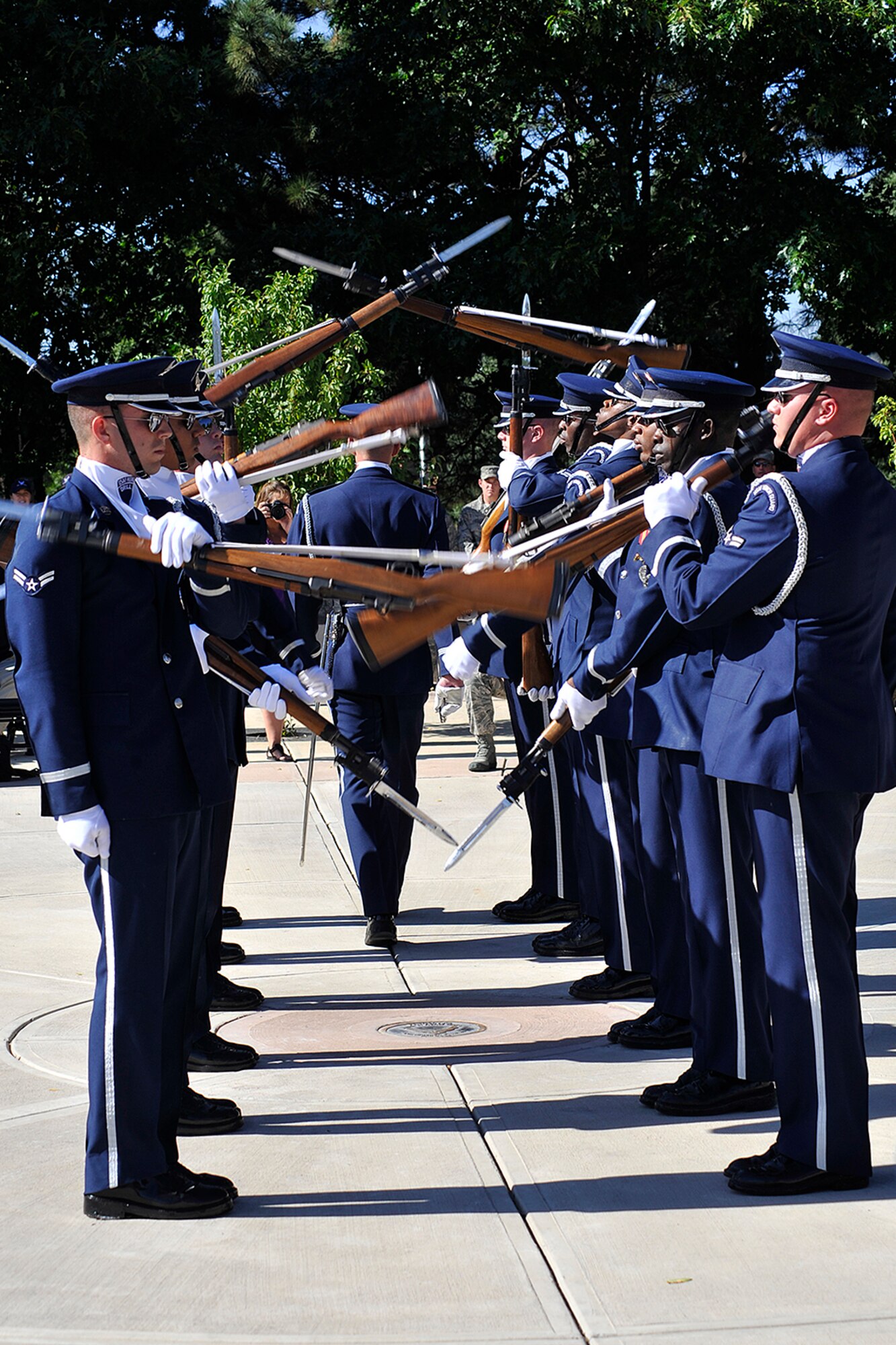 PETERSON AIR FORCE BASE, Colo. -- The Air Force Honor Guard Drill Team performs Sept. 29 at Peterson Air Force Base Museum's Medal of Honor Park. The drill team wowed the Peterson crowd with a variety of tightly choreographed maneuvers, including a routine during which drill team members simultaneously hurled their 11-pound weapons over and around their commander. The drill team is the traveling component of the Air Force Honor Guard and tours Air Force bases worldwide, showcasing the precision of today's Air Force to recruit, retain, and inspire Airmen for the Air Force mission. (U.S. Air Force photo/Rob L. Bussard)