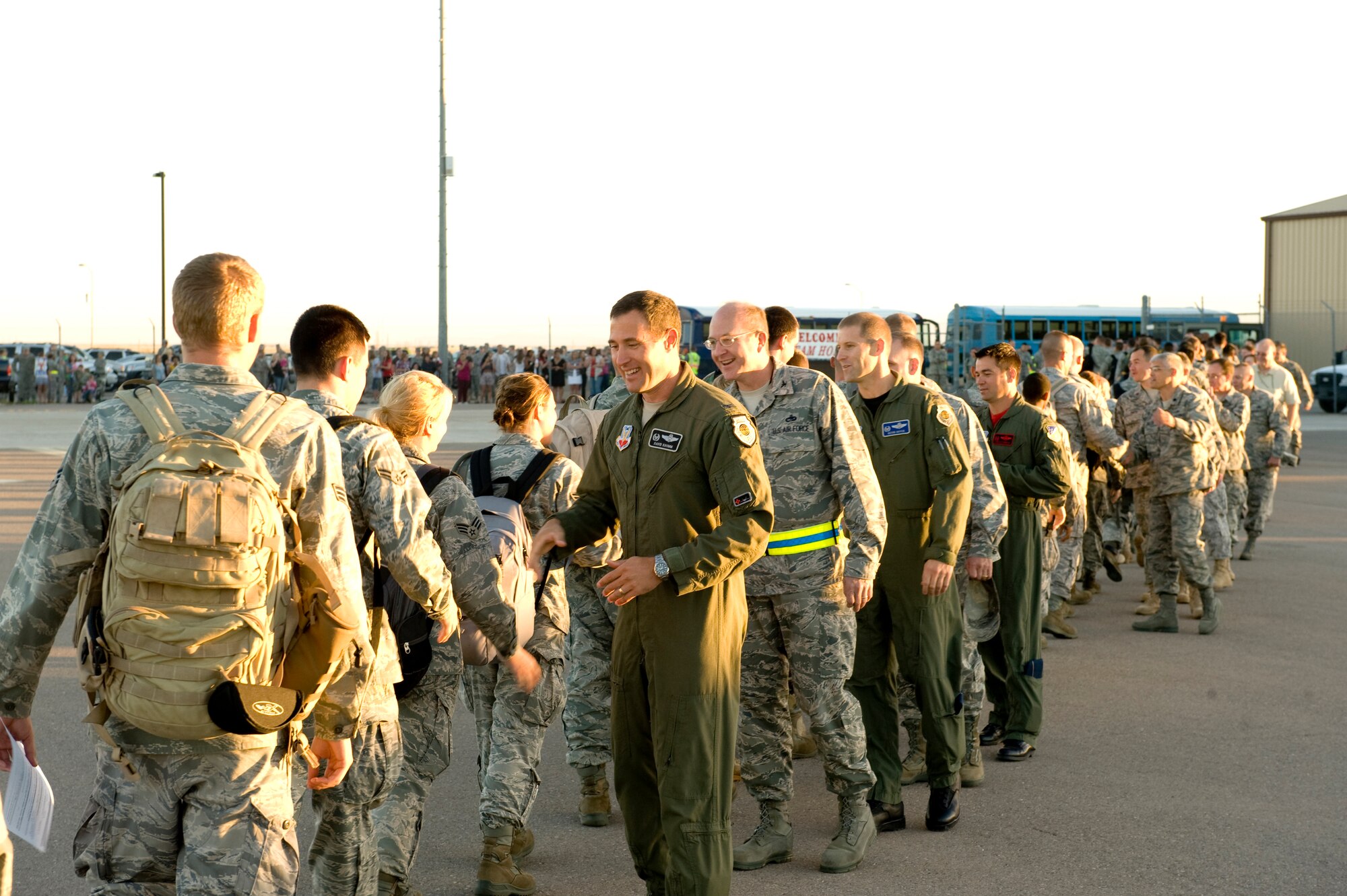 HOLLOMAN AIR FORCE BASE, N.M. -- Commanders with the 49th Wing greet returning deployers Oct. 1, 2010, after a deployment to Japan. The deployment sent 285 'Fightin' 49ers' and 12 F-22A Raptors to the island of Okinawa, Japan, where clear airspace overhead and miles of water around allowed the fifth generation fighters to train alongside Kadena Air Base's F-15C Eagles and KC-135 Stratotankers, while also working with Marine Corps F/A-18 Hornets. (U.S. Air Force photo by Tech. Sgt. Alan Port / Released)