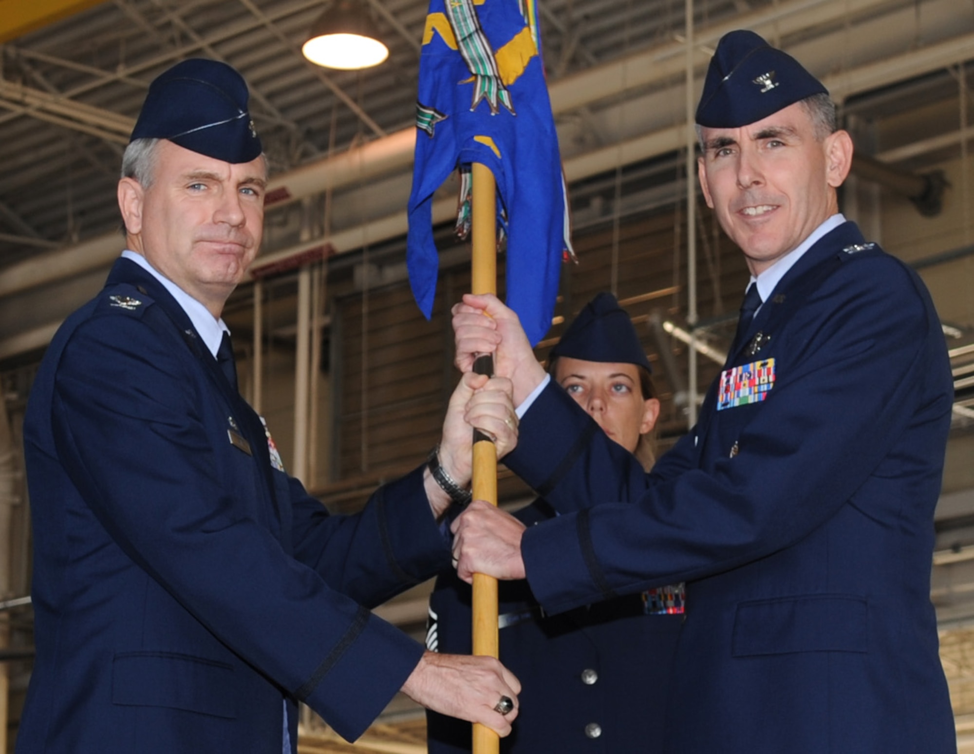 BARKSDALE AIR FORCE BASE, La. ? Col. Timothy Fay (left), 2nd Bomb Wing commander, passes the guidon to the new 2nd Operations Group Commander Col. John Vitacca at a change-of-command ceremony Oct. 4. Col. Gregory Smith, former 2 OG commander, will move on to become deputy director of Strategic Plans and Programs, Air Force Global Strike Command. The change-of-command ceremony is a military tradition that gives service members the opportunity to view their new leader take command.  (U.S. Air Force photo/Senior Airman Amber Ashcraft) (RELEASED)