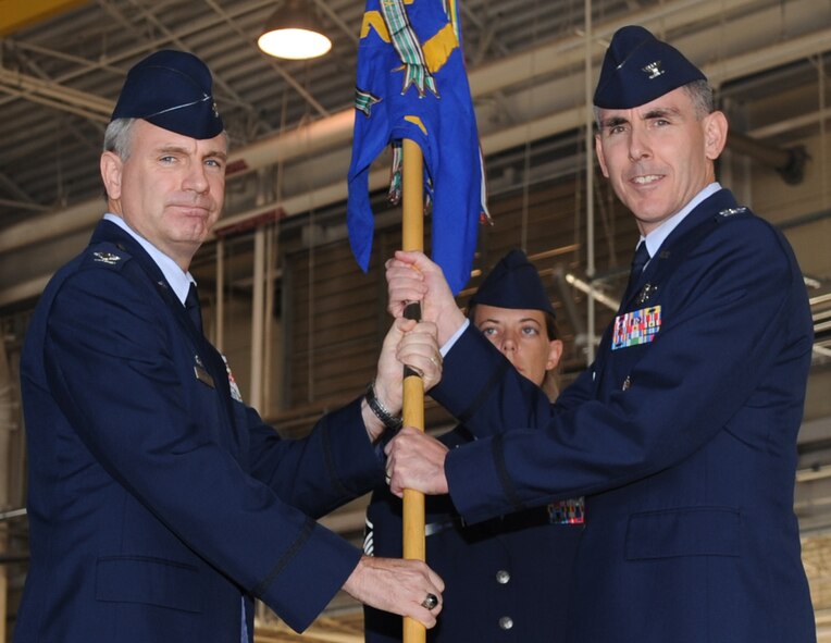BARKSDALE AIR FORCE BASE, La. -- Col. Timothy Fay (left), 2nd Bomb Wing commander, passes the guidon to the new 2nd Operations Group Commander Col. John Vitacca at a change-of-command ceremony Oct. 4. Col. Gregory Smith, former 2 OG commander, will move on to become deputy director of Strategic Plans and Programs, Air Force Global Strike Command. The change-of-command ceremony is a military tradition that gives service members the opportunity to view their new leader take command. (U.S. Air Force photo/Senior Airman Amber Ashcraft) (RELEASED)