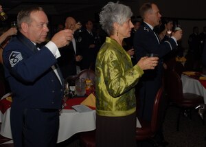 Guests of the 940th Wing Dining Out event give a traditional toast to the wing, Oct 2. at the Recce Point Club on Beale Air Force Base, Calif. The dining out is a long-standing Air Force tradition. (U.S. Air Force photo/ Tech. Sgt. Kenneth McCann)