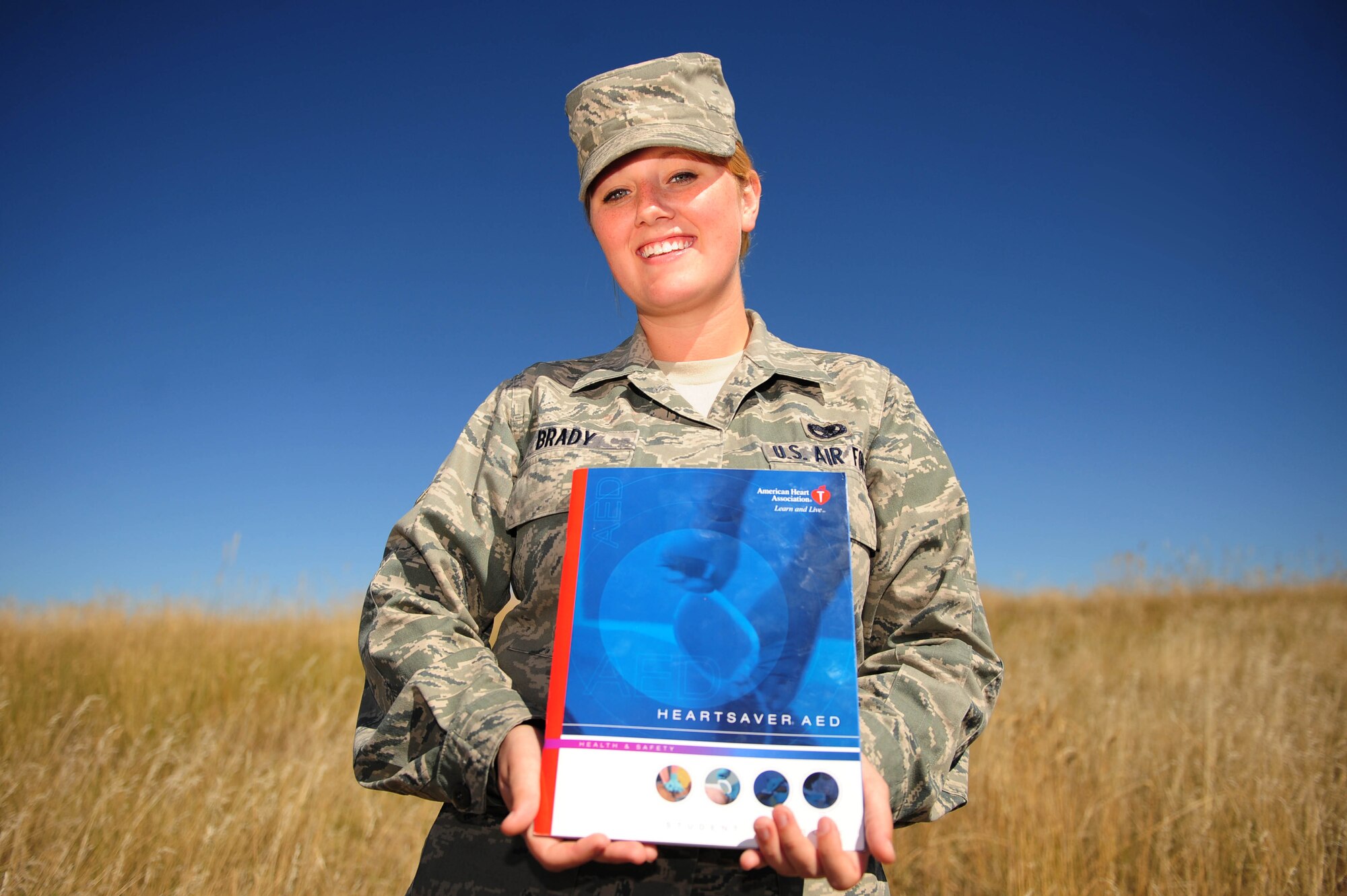 ELLSWORTH AIR FORCE BASE, S.D. – Airman 1st Class Ashley Brady, 28th Maintenance Squadron isochronal maintenance apprentice, holds a book containing cardiopulmonary resuscitation training, Sept. 28. Airman Brady saved Raymond Bald Eagle’s life, with CPR training, during a visit to Cold Brook Lake in Hot Springs, S.D. She learned CPR through the Air Force and her college. (U.S. Air Force photo/Senior Airman Corey Hook) 