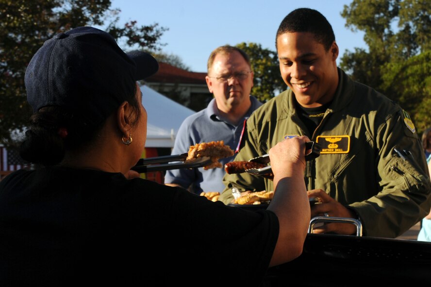 BARKSDALE AIR FORCE BASE, La. -- Lt. Matthew Small, 11th Bomb Squadron, grabs some food during Oktoberfest Oct. 1. Traditional German food such as schnitzel, bratwurst, sauerkraut, kartoffelsalat and pretzels were served. (U.S. Air Force photo/Senior Airman Brittany Y. Bateman)(RELEASED)