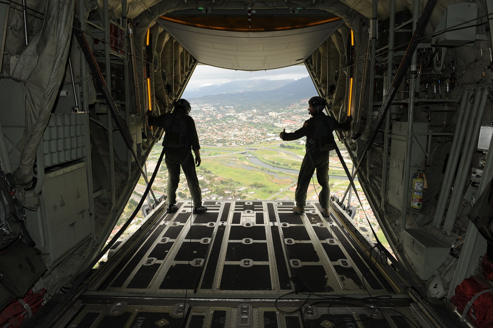 Master Sgt. Rich Baarda (left) and Master Sgt. Kyle Grunon (right), members of the 143rd Airlift Wing, Rhode Island Air National Guard unit located at Quonset Point, Rhode Island, stand at the open back end of the C-130J during a validation flight on Sept. 20, 2010, for the Africa Aerospace & Defence (AAD) 2010 in Cape Town, South Africa. (U.S Air Force Photo/Staff Sgt. David J. Murphy)