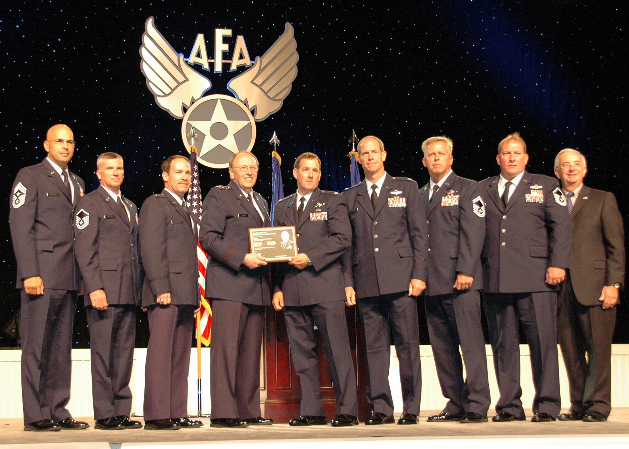 From left:  Chief Master Sgt. Michael Klausutis; Master Sgt. Bruce Callaway; Lt. Col. Timothy Broeking; Lt. Gen. Charles E. Stenner Jr., commander of the Air Force Reserve Command and chief of the Air Force Reserve; Lt. Cols. Daniel Flynn and Thomas Frazier; Senior Master Sgt. Thomas Haddock; Master Sgt. Kevin Woodward; and Joseph Sutter, Air Force Association chairman of the board, are shown at the annual AFA awards ceremony at National Harbor, Md. in September. General Stenner and Mr. Sutter joined the Duke Field reservist aircrew members on stage as they were presented the AFA's 2009 Lt. Gen. William H. Tunner award for the Air Force's most outstanding airlift aircrew .  Crew members not shown:  Lt. Col. Steven Jensen and Capt. Miriam Williams. (U.S. Air Force photo/Dan Neely)