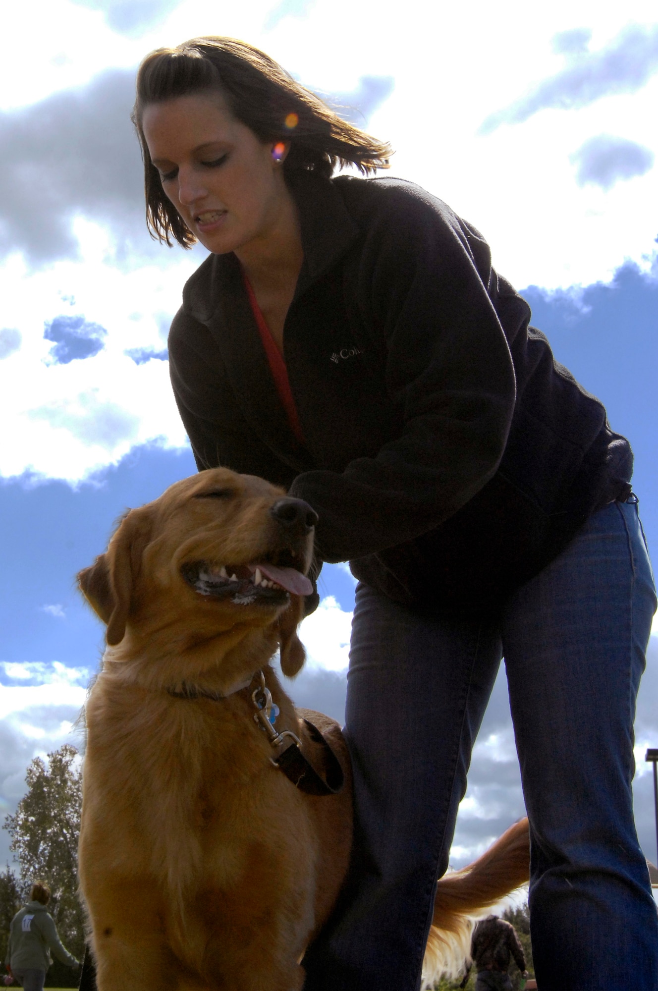 WHITEMAN AIR FORCE BASE, Mo. - Chloe, a golden retriever, stands as her owner, Bethany Lester, grooms her Oct. 2 for the 2010 Bark in the Park. Chloe won first place in the musical sit contest. The annual event was hosted by the Whiteman Community Activities Center and Vet Clinic and is part of the Air Force Global Strike Command values for Airmen moral and welfare. (U.S. Air Force photo/Senior Airman Jason Barebo)