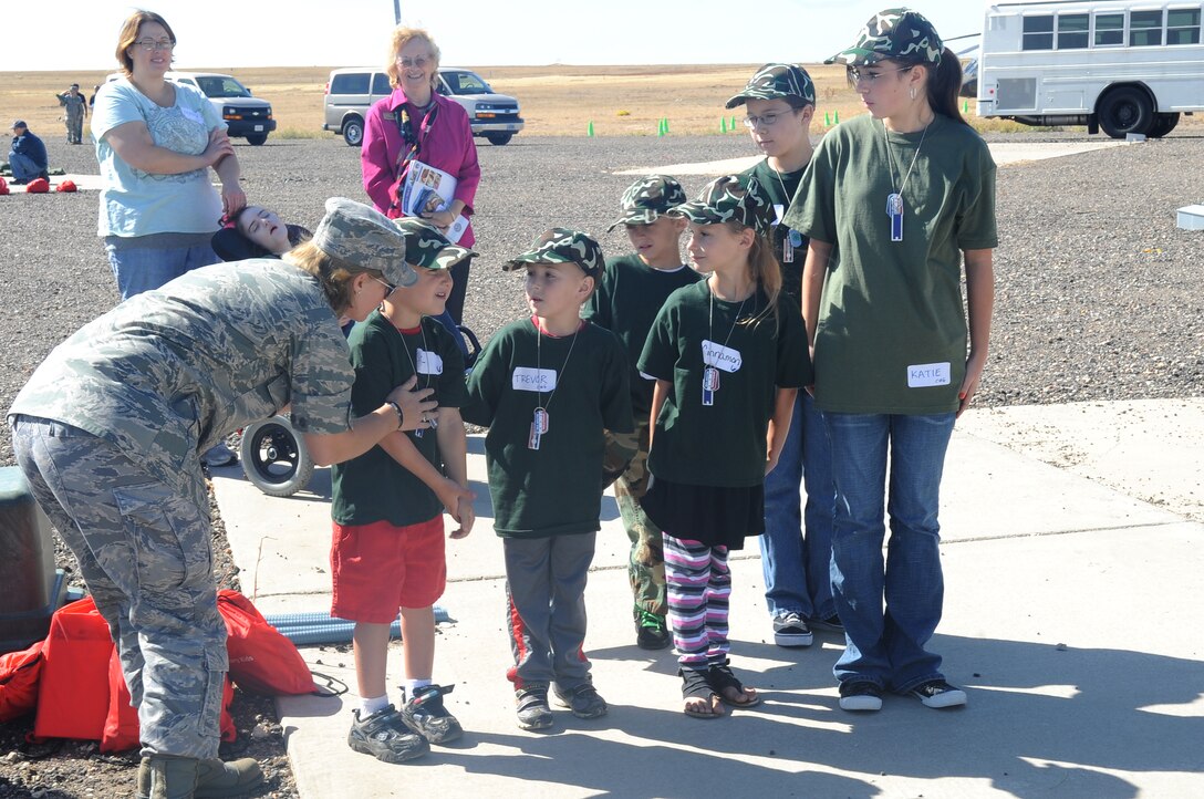 BUCKLEY AIR FORCE BASE, Colo. -- Children of various ages learn how to march at the Family Mock Deployment Oct. 2 at Camp Rattlesnake. "Deployment chalks" cycled between several different stations to experience each part of deployment preperation. (U.S. Air Force Photo by Airman Manisha Vasquez) 