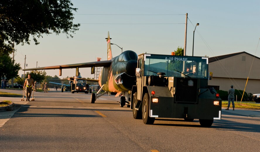 MOODY AIR FORCE BASE, Ga. -- Members of the 23rd Equipment Maintenance Squadron maintenance flight tow an A-7D Corsair II down Davis Street Oct. 3. The crew towed the A-7, an A-10 Thunderbolt II and an F-105 Thunderchief to what will soon be the Moody’s Heritage Park. (U.S. Air Force photo/Senior Airman Jamal D. Sutter)