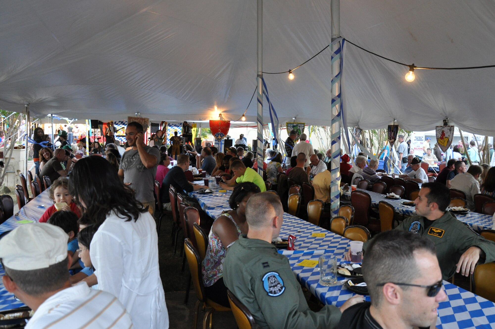 Attendees sit down for a complete authentic German meal at the 3rd Annual Oktoberfest celebration at Barksdale Air Force Base, La., Oct. 1, 2010. The price of admission included bratwurst, schnitzel, German potato salad, and a roll; along with 2 beverages and a commemorative Oktoberfest cup. Partygoers talked, ate, sang and danced, while others participated in the keg rolling and a costume contest. (U.S. Air Force photo/Tech. Sgt. Jeff Walston)