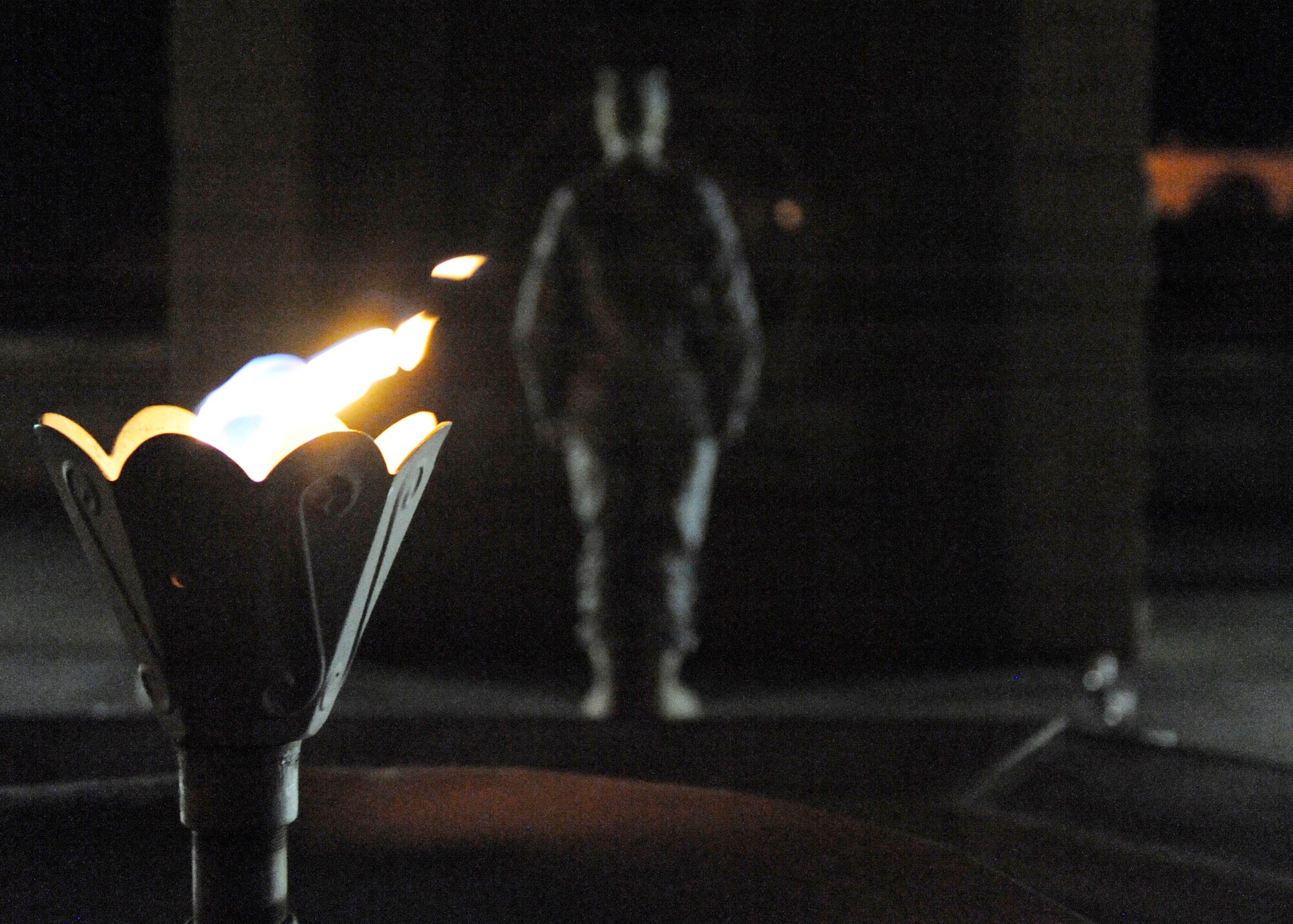 HOLLOMAN AIR FORCE BASE, N.M. -- A Holloman Airman stands vigil in front of the Prisoners of War/Missing in Action memorial at Heritage Park Sept. 30, 2010, as part of the 2010 POW/MIA Remembrance Week. Airmen stood at attention in front of the memorial in 30-minute increments for a total of 24 hours, while the eternal flame remained lit behind them, signifying continued remembrance and unwavering resolve for America's POW and MIAs. (U.S. Air Force photo by Airman 1st Class Eileen Payne / Released)