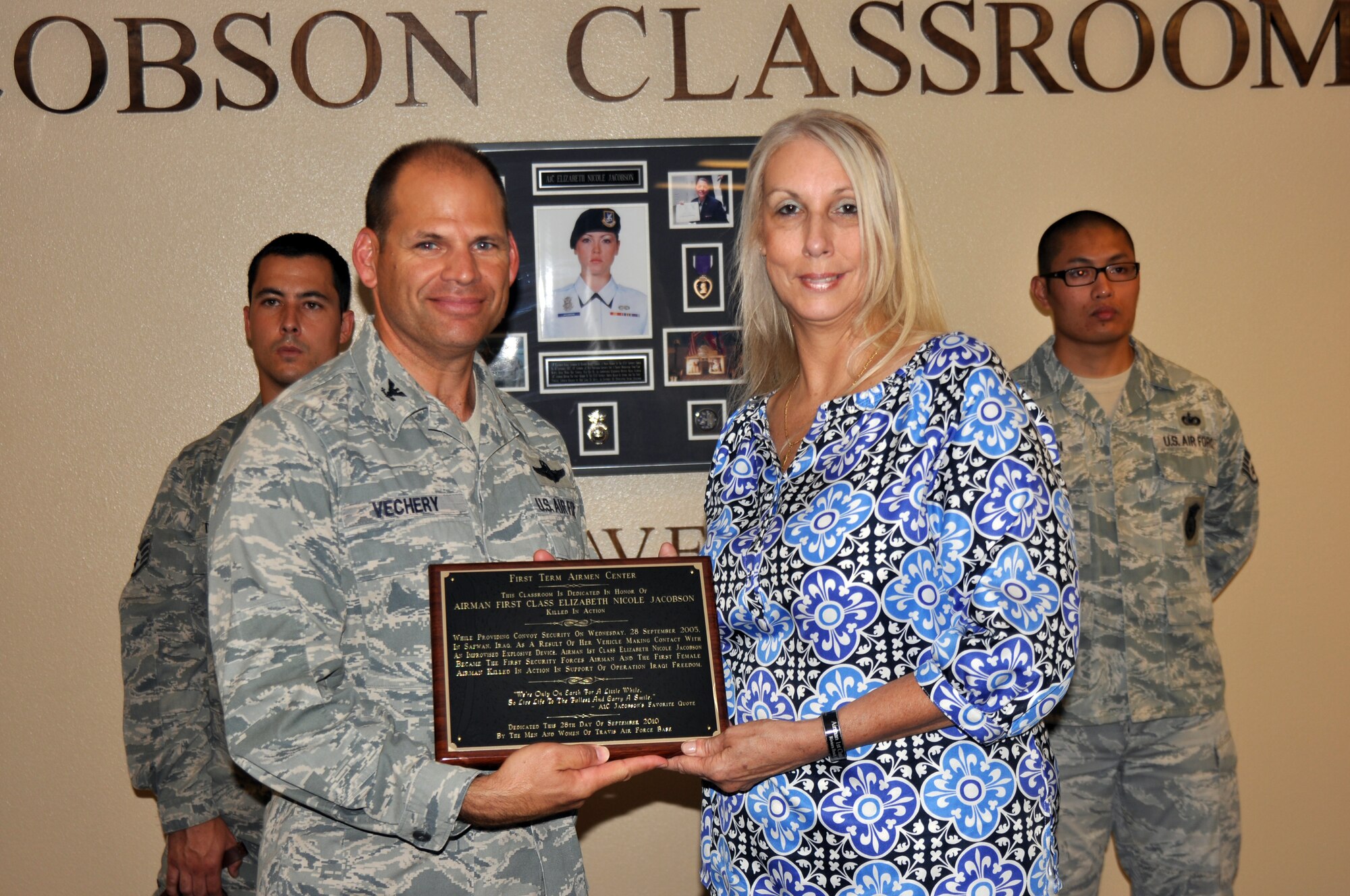 Col. Jim Vechery, 60th Air Mobility Wing commander, stands with the mother of the late Airman 1st Class Elizabeth Jacobson during a Sept. 26 ceremony renaming Travis' First term Airman Center after her. Airman Jacobson died during Operation Iraqi Freedom. (U.S. Air Force photo/ Airman 1st Class Michael Battles)