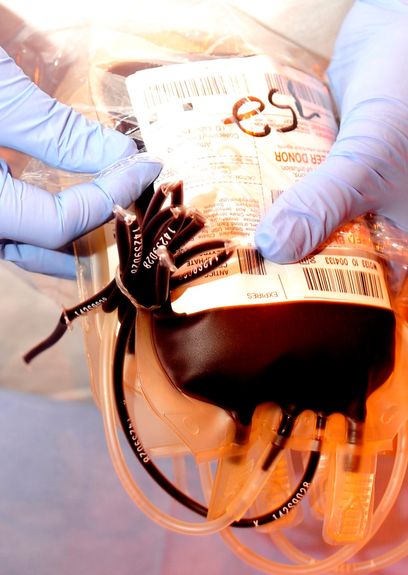 RAF MILDENHALL, England -- An Armed Services Blood Program medical lab technician prepares a bag of donated blood for transport here Sept. 30. The blood is bagged, labeled and put on ice while it awaits transport to a proper holding facility. (U.S. Air Force photo/Senior Airman Ethan Morgan)