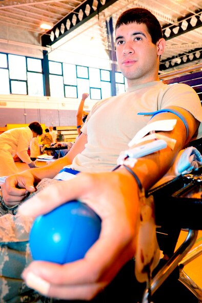 RAF MILDENHALL, England -- Airman 1st Class Donovan Ortiz, 100th Logistics Readiness Squadron, donates blood at the blood drive here Sept. 30.  The blood drive was held as part of the Armed Services Blood Program. (U.S. Air Force photo/Senior Airman Ethan Morgan)