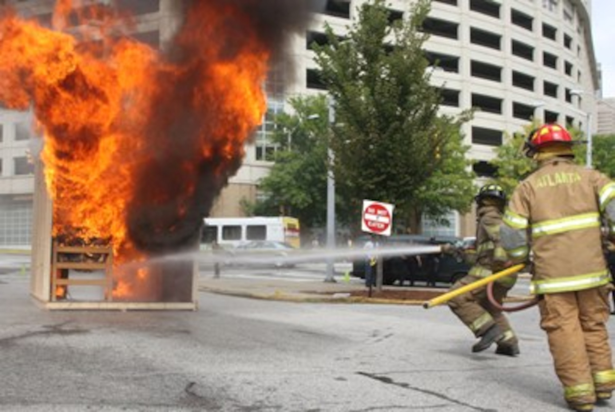 Firefighters from Dobbins and the City of Atlanta start fires in two mock dormitory rooms, one with and one without sprinkler systems to demonstrate how fast fires spread and how valuable sprinklers are. The demonstration was a part of a fire safety awareness program sponsored by the University of Georgia, Atlanta, Ga., Sept. 30. (U.S. Air Force Photo/Don Peek)