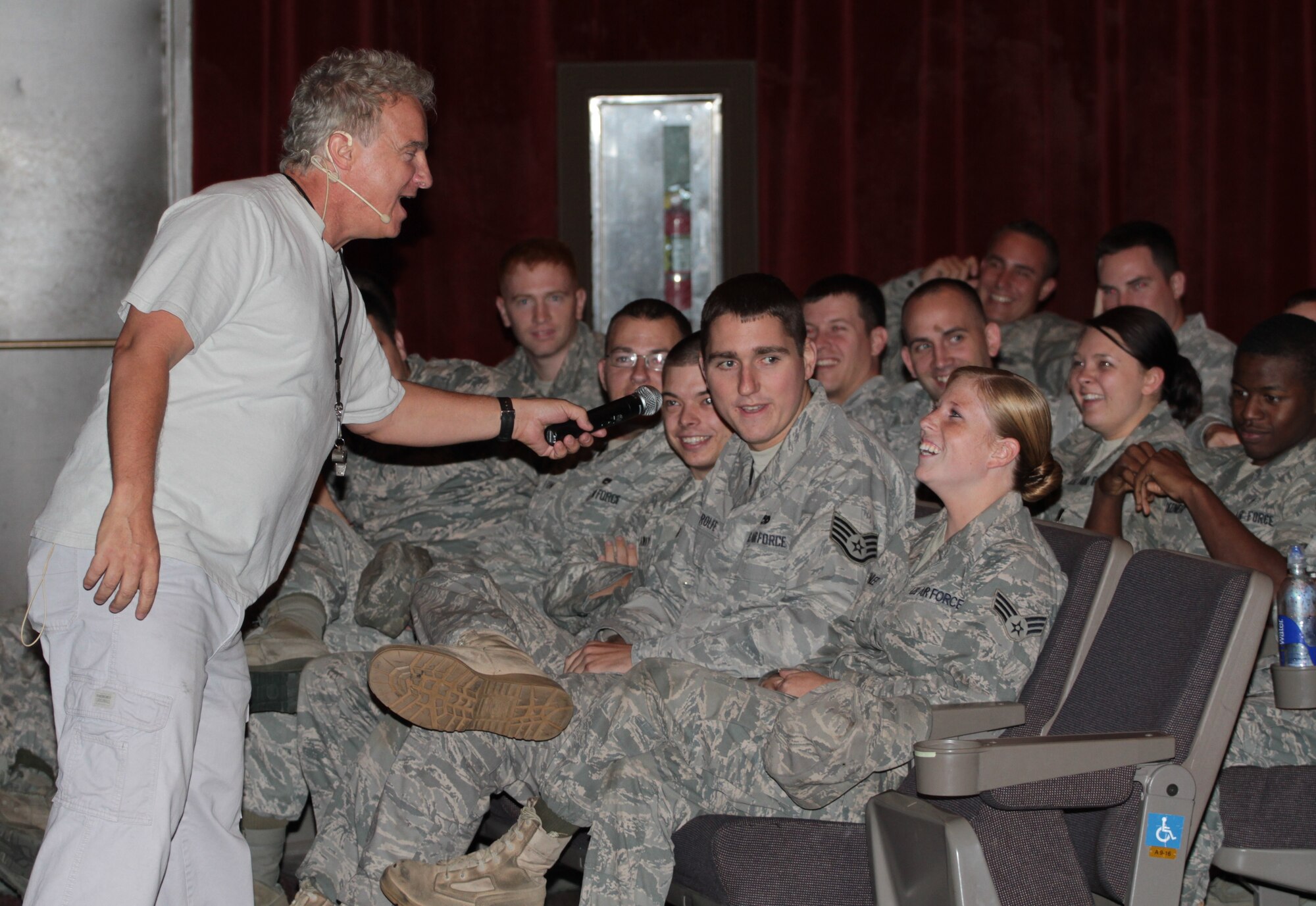 Steve Verret, an Improv Comedy Club Traffic School traffic safety comedian, asks the audience for their traffic safety input during a safety briefing Sept. 30 at the base theater. Mr. Verret offers a fresh way to deliver traffic safety information by using comedic relief to keep the audience entertained. (U.S. Army photo by Spc. Jared Sollars)
