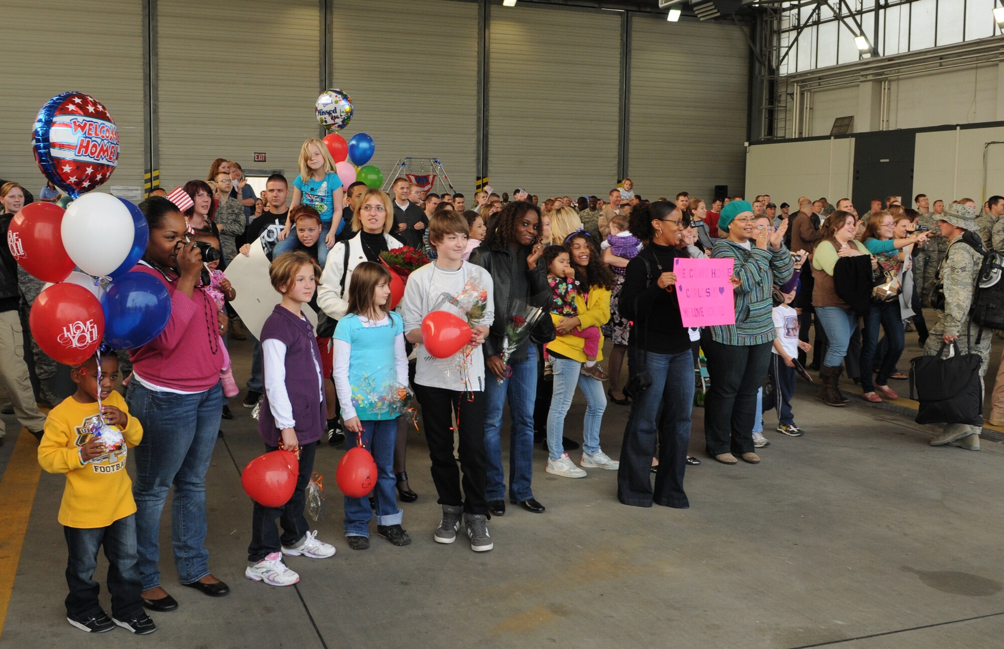 SPANGDAHLEM AIR BASE, Germany – The family and friends of returning deployers wait on the flightline to greet their loved ones Oct. 1. The returning Airmen were deployed for five months in support of the 81st Fighter Squadron. (U.S. Air Force photo/Staff Sgt. Benjamin Wilson)