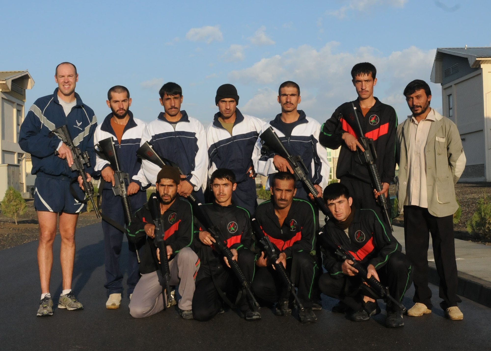 Members of the Afghan Air Force Security Force engage in physical fitness with NATO Air Training Command - Afghanistan advisor, Capt. Robert Shaw on Sept 30, 2010.  (U.S. Navy photo by MC3 Jared Walker/RELEASED).