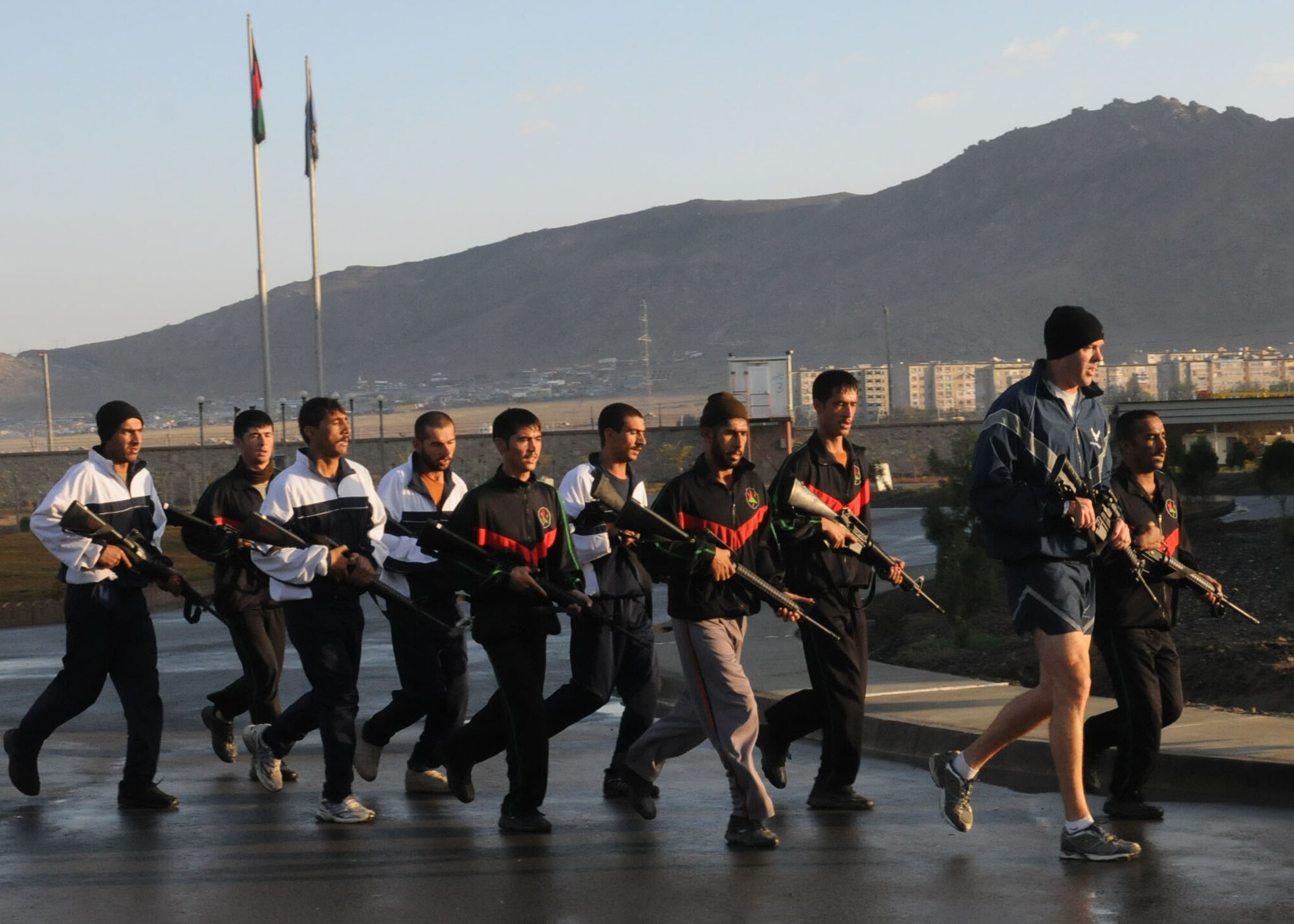 Members of the Afghan Air Force Security Force engage in physical fitness with NATO Air Training Command - Afghanistan advisor, Capt. Robert Shaw on Sept 30, 2010.  (U.S. Navy photo by MC3 Jared Walker/RELEASED).