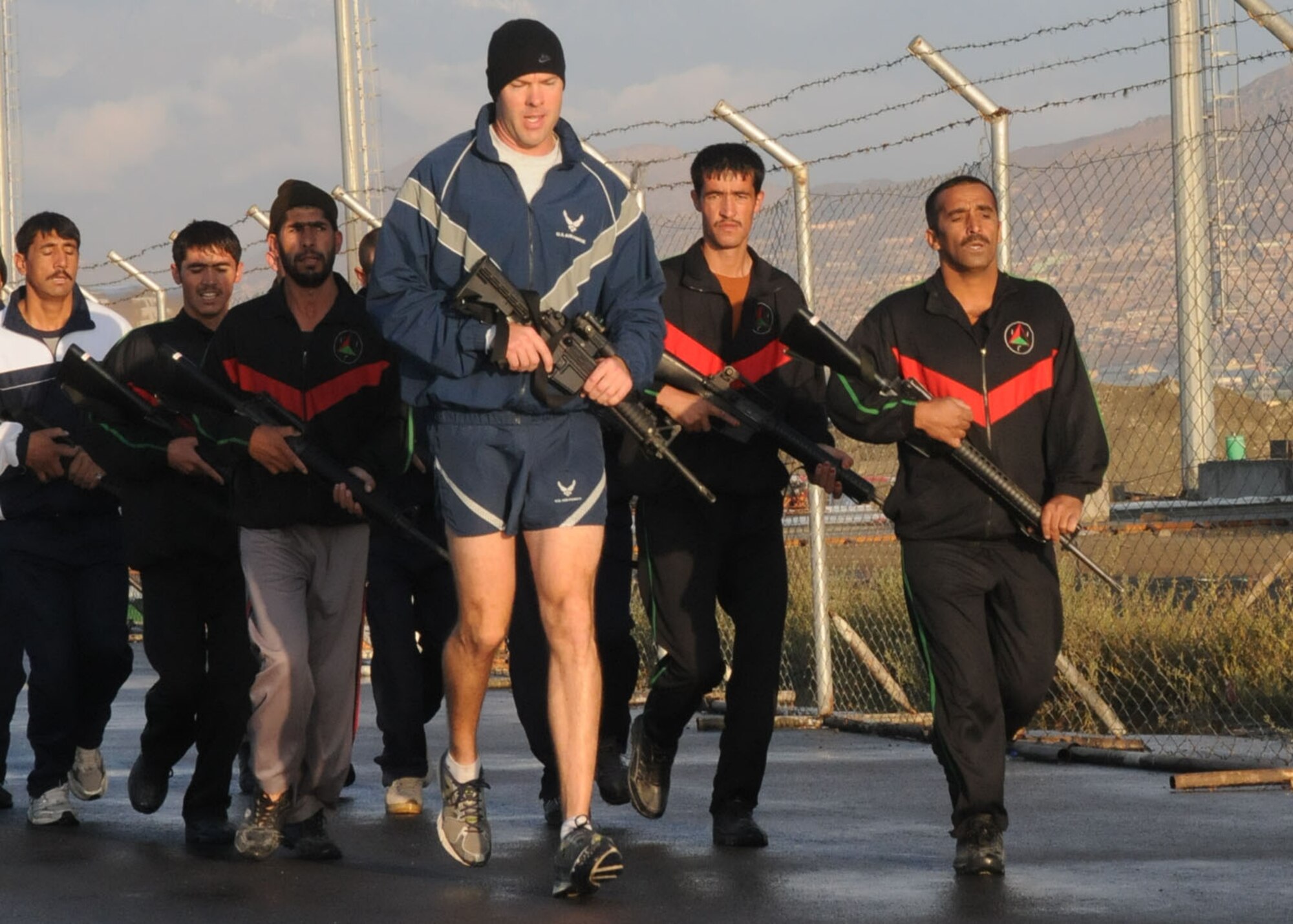 Members of the Afghan Air Force Security Force engage in physical fitness with NATO Air Training Command - Afghanistan advisor, Capt. Robert Shaw on Sept 30, 2010.  (U.S. Navy photo by MC3 Jared Walker/RELEASED).